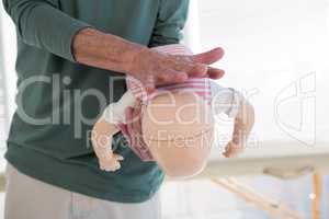 Paramedic demonstrating resuscitation on a infant dummy