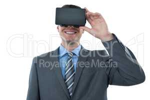 Businessman using virtual reality headset against white background