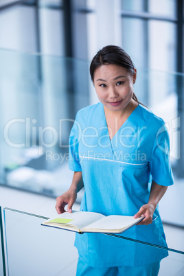 Nurse holding a diary in hospital