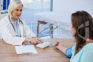 Female doctor checking blood pressure of a patient