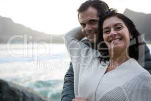 Portrait of romantic couple embracing each other on beach