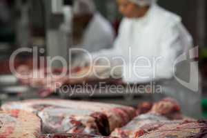 Close-up of raw meat on worktop at meat factory