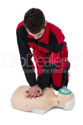 Paramedic practising resuscitation on dummy