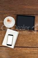 Digital tablet with smartphone and cup of coffee