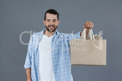 Happy man holding shopping bags