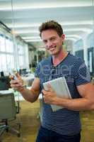 Male business executive using on mobile phone in office