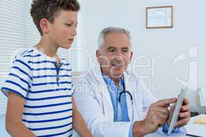 Doctor and patient having discussion over digital tablet