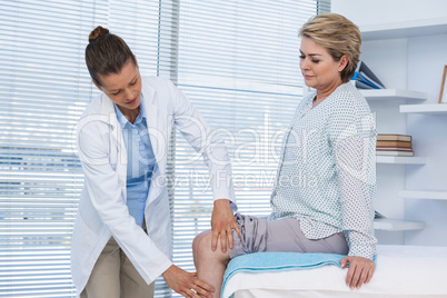 Doctor examining patient knee