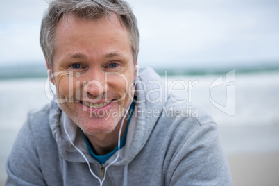 Portrait of handsome man listening music on headphones