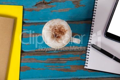 Coffee mug, notepad, smartphone, pen and diary