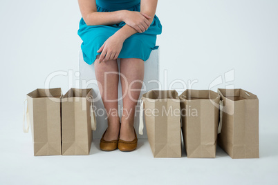 Woman sitting with shopping bags