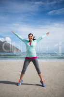 Happy woman standing with arms outstretched