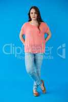 Beautiful woman standing against blue background