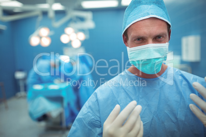 Portrait of male surgeon wearing surgical mask in operation theater