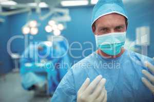 Portrait of male surgeon wearing surgical mask in operation theater