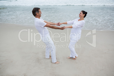 Romantic couple holding hands on beach