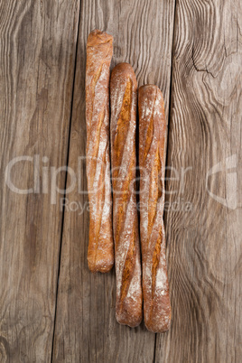 Baguettes on wooden background