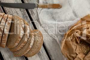 Sliced loaf of bread with knife