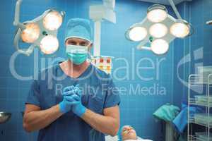 Portrait of male surgeon standing in operation theater