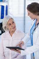 Doctor discussing with patient over digital tablet