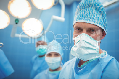 Portrait of male surgeon wearing surgical mask in operation theater