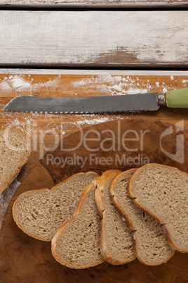 Sliced bread with knife on cutting board