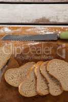 Sliced bread with knife on cutting board