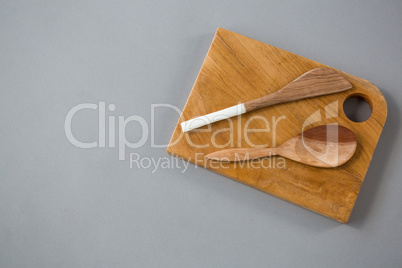 Wooden knife and spoon on chopping board
