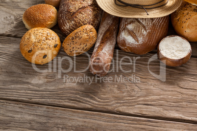 Various bread loaves with flour and wheat