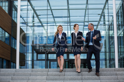 Businesspeople climbing down the steps