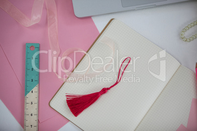 Diary, bookmark, ruler, ribbon and laptop