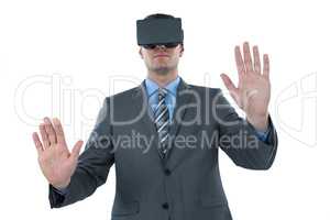 Businessman using virtual reality headset against white background