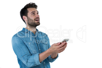 Man dreaming while holding a mobile phone