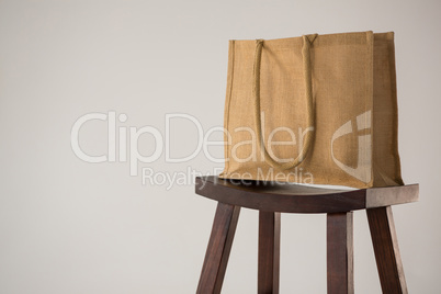 Jute bag on wooden stool
