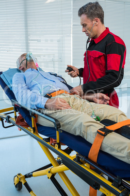 Paramedic checking blood pressure of patient