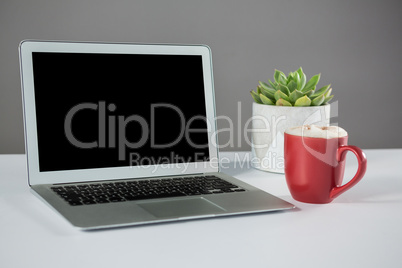 Laptop with cup of coffee
