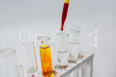 Blood sample being drop into test tubes