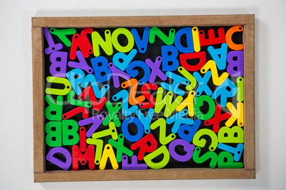 Multicolored Jumbled alphabets on slate board