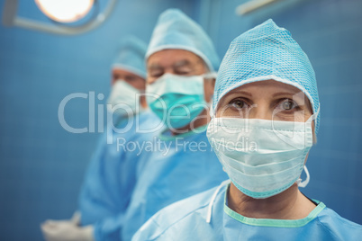 Portrait of female surgeon wearing surgical mask in operation theater