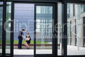 Businessman showing digital tablet to his colleague