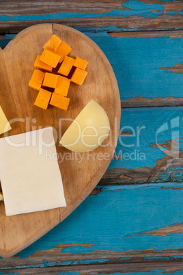 Variety of cheese on heart shaped chopping board