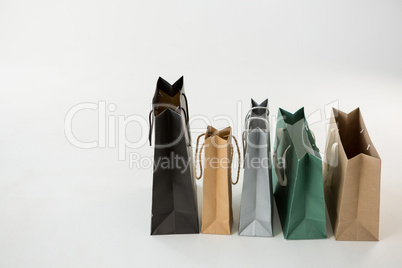 Various paper shopping bags in row