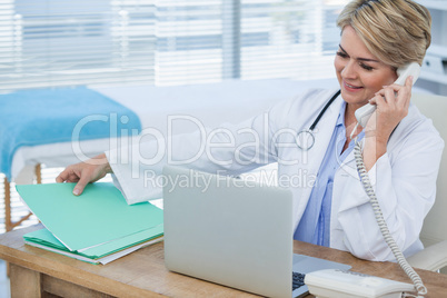 Female doctor talking on telephone