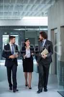 Businesswoman walking with colleagues