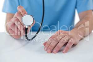 Surgeon holding a stethoscope