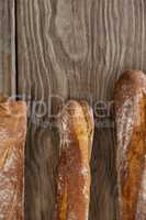 Baguettes on wooden background