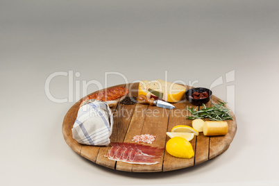 Cheese, ham and bread with various ingredients on chopping board