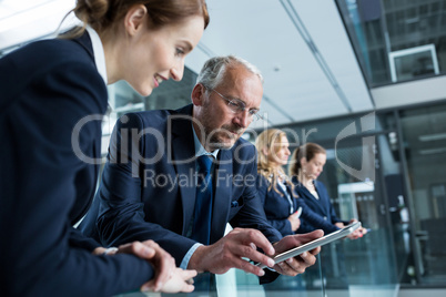 Businessman with colleague using digital tablet
