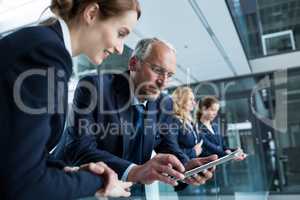 Businessman with colleague using digital tablet