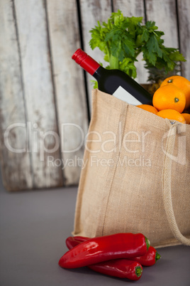 Wine bottle and vegetables in grocery bag